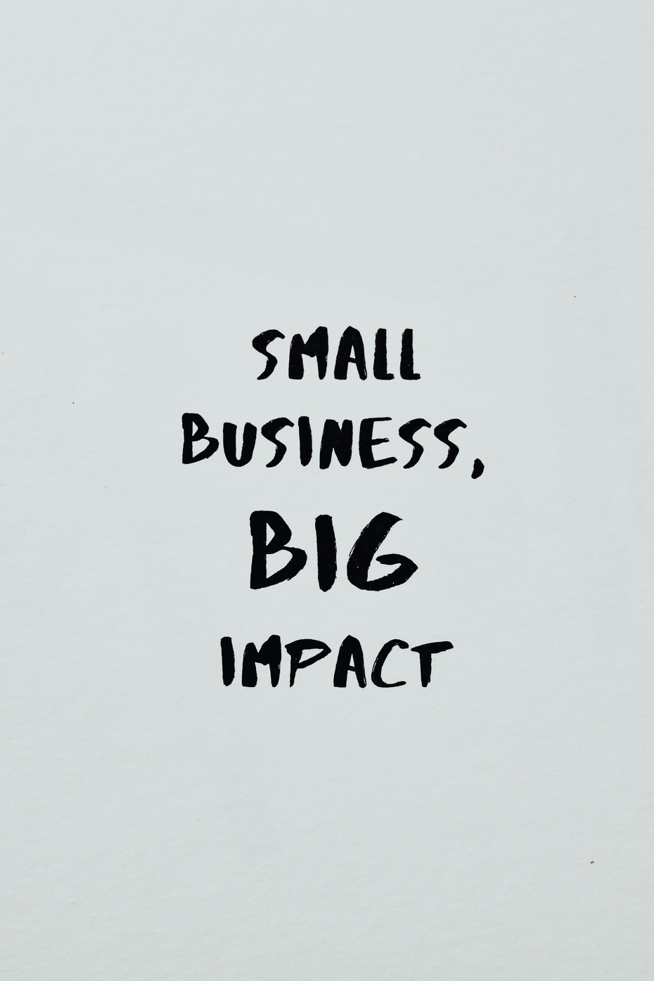 Small Business Big Impact Text on a White Surface
